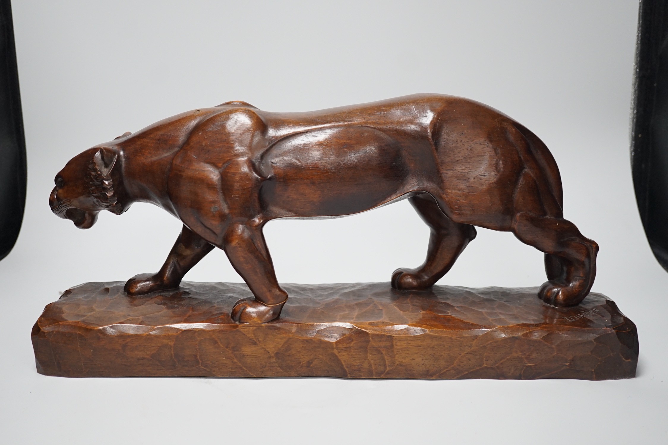 A French carved walnut model of a tiger, signed Chartron, 47cms wide